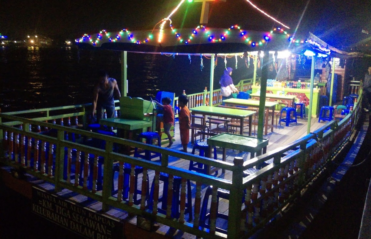 cruising kapuas river at night on tourist ship